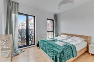 Katil atau katil-katil dalam bilik di Dwie Motławy Apartinfo Apartments