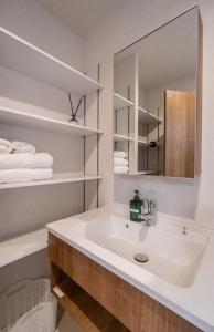 a bathroom with a sink and a mirror at HANASTAY花渓居 · 澄（KIYOSI) in Osaka +63 photos