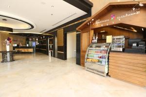 a grocery store with a counter and a refrigerator at Quiet Dreams - King Road Branch in Jeddah