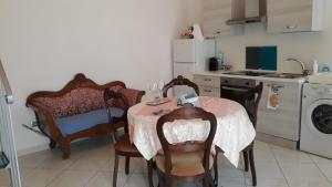 a kitchen with a table and chairs and a kitchen with a washing machine at Mini Location Chieti in Chieti