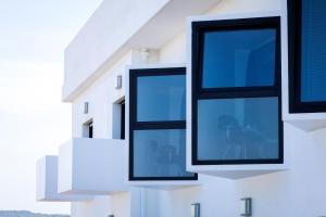 two windows on the side of a building at Le Grand Hotel de la Plage in Biscarrosse-Plage