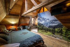 a bedroom with a bed and a large painting on the wall at A Nouste chambres d'hotes et gite ONLY ADULTS in Campan