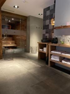 a bathroom with a shower and a tile floor at Mountain See Lodge in See