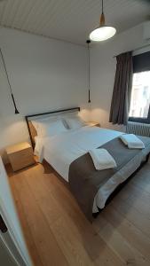 a bedroom with a large white bed in a room at KYRIAKOS APPARTMENT in Monemvasia