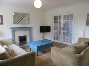 a living room with two couches and a blue coffee table at Duck's Nest in Heacham