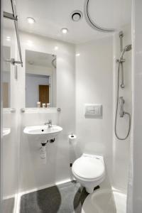 a white bathroom with a toilet and a sink at Central Single Room With Shared Kitchen in Luton in Luton