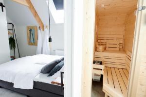 a bedroom with a bed and a small staircase at Wellness Lodges x De IJsvogel in Voorthuizen