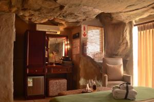 a bedroom with a bed and a rock wall at Kagga Kamma Nature Reserve in Lochlynne +90 photos
