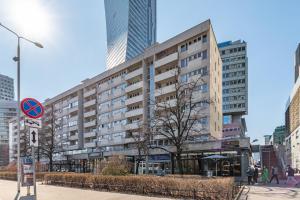 a large building in a city with tall buildings at Apartament Emilii Plater by Your Freedom in Warsaw