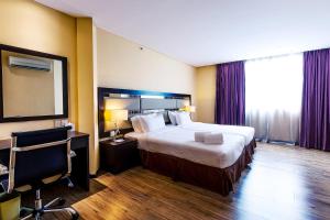 Postel nebo postele na pokoji v ubytování Ixora Hotel Penang