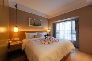 Postel nebo postele na pokoji v ubytování CM Serviced Apartment