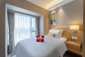 Postel nebo postele na pokoji v ubytování CM Serviced Apartment