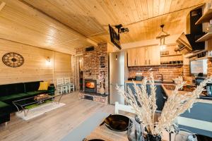a living room with a couch and a fireplace at Sweet Escape Vlădeasa in Rogojel