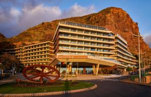 a large building with a clock on top of it at Saccharum - Hedonist Design Resort in Calheta