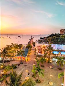 a view of the beach and the ocean at sunset at Hotel Slipway in Dar es Salaam