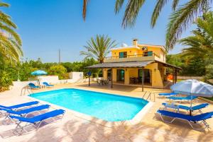a swimming pool with chairs and a house at Villa Noni Large Private Pool AC WiFi in Polis Chrysochous