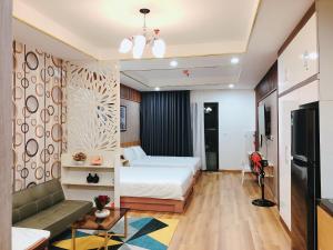 a hotel room with a bed and a couch at TMS Quy Nhơn - RUBY Luxury Apartment in Quy Nhon