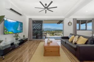 a living room with a couch and a tv at SEA-Renity on Castle Hill in Townsville