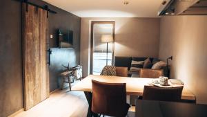 a dining room with a table and a living room at Mountain See Lodge in See