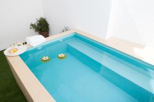 a swimming pool with blue water in a house at Alhondiga piso nuevo piscina Casco Antiguo8P in Seville