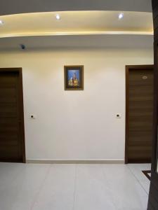 a room with two doors and a picture on the wall at hotel s.s royal in Amritsar