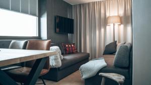 a living room with a couch and a chair at Mountain See Lodge in See