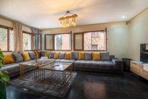 a living room with a couch and a table at Chalet Asmoun 2 in Imouzzer du Kandar