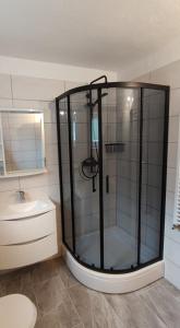 a bathroom with a shower and a sink at Apartman Juresic in Rab
