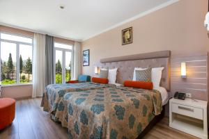 a hotel room with a bed and a window at Orange County Kemer Family Concept in Kemer