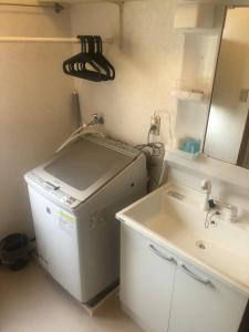 a small bathroom with a sink and a mirror at 今市STAY - NIKKO private house rental only 5 min to station in Nikko