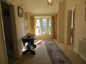 a hallway with a table and a large window at The Vicarage Apartment in Hunstanton