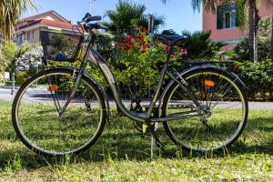 a bike parked in the grass in a yard at Residence Greco & Linda in San Bartolomeo al Mare