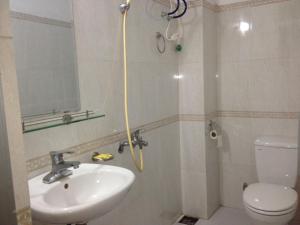 a bathroom with a shower and a sink and a toilet at Hai Trang Hotel in Ha Long