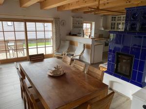 a kitchen and dining room with a table and a fireplace at Chalupa Pecivál Lipno in Lipno nad Vltavou