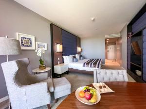 a room with a bed and a table with a bowl of fruit at InterContinental Cascais-Estoril by IHG in Estoril