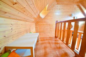 a wooden room with a bench in the middle of a room at Beverly B&B in Ren'ai