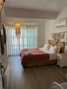a bedroom with a large bed and a chandelier at Alacati Boreas Hotel in Alaçatı