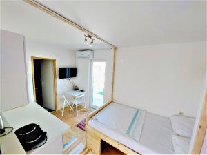 a small room with a bed and a desk at Studio apartment Murter Center in Murter