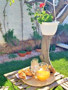 a tray of orange juice and bread on a table at Studio apartment Murter Center in Murter +8 photos