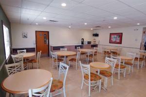 a room with tables and stools in a restaurant at Microtel Inn and Suites by Wyndham Ciudad Juarez, US Consulate in Ciudad Juárez