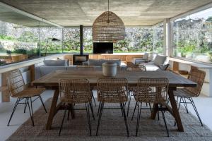 a dining room with a wooden table and chairs at Casa dos Cabeçudos in Afife