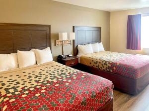 a hotel room with two beds in a room at Econo Lodge Inn & Suites Corning in Corning