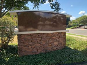 a large screen on top of a brick wall at Sonesta ES Suites San Antonio Northwest Medical Center in San Antonio
