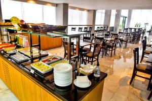 a breakfast buffet in a restaurant with tables and chairs at Days Inn By Wyndham Cascavel in Cascavel
