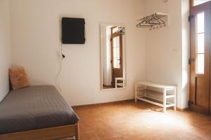 a small bedroom with a bed and a mirror at Rekreační dům U Skřítků in Mladé Buky