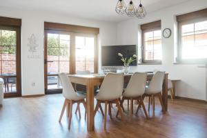 a dining room with a wooden table and chairs at Rekreační dům U Skřítků in Mladé Buky