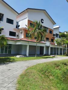un bâtiment avec un palmier en face dans l'établissement C 13 Lot 10 Pangkor Leisure Beach Studio, à Île de Pangkor