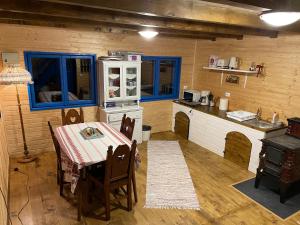 a kitchen with a table and a stove in a room at Casa Brună in Băile Olăneşti
