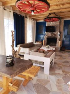 a living room with a couch and a table at Apo Petra in Agia Marina Aegina