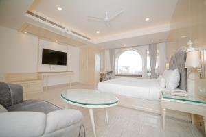 a bedroom with a bed and a table and a couch at Pearl Courtyard in Varanasi +74 photos